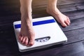 Women's feet are on mechanical scales for weight control