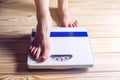 Women's feet are on mechanical scales for weight control