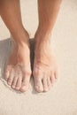 Women's feet in the sand Royalty Free Stock Photo