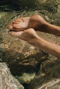 Women's feet in the sea. Close-up top view of a young woman's bare feet in a water Royalty Free Stock Photo