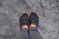 Women`s feet in sneakers stand on concrete on the street, view from top to bottom Royalty Free Stock Photo