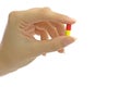 Women's fingers with pill