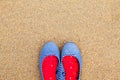 Women`s flat summer shoes, against a sand background