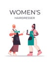 Women`s hairdressers discussing during meeting mix race girls in uniform standing together beauty salon concept