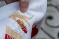 Women's hand embroidery in a hoop, a woman embroider a pattern on dark material. Close-up. The concept of needlework, hobby,
