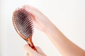 Women`s hand hair brush with hair loss, dandruff and health pr Royalty Free Stock Photo