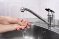 A women's hand helps child to washes his hands Royalty Free Stock Photo