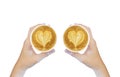 Women`s Hand holding cup of cappuccino coffee with heart shape latte art  on white background, Latte coffee on white Royalty Free Stock Photo