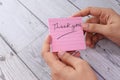 Women`s hand holding thank you note , top down Royalty Free Stock Photo