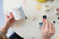 Women`s hands pain a simple pattern to a ceramic teacup. Learning new skills, improving skills, hobbies. Selective focus