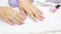 Women`s hands with a beautiful manicure on a white background. Manicure. Pink manicure, nail art, glitter Polish. Nude, pastel,