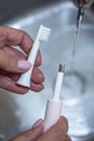 women& x27;s hands close up washing a toothbrush Royalty Free Stock Photo