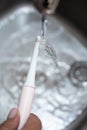 women's hands close up washing a toothbrush Royalty Free Stock Photo