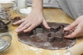 Women& x27;s hands cooking festive Christmas gingerbread cookies. Cooking chocolate cookies or dessert Royalty Free Stock Photo