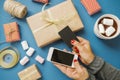 Women`s Hands with Credit Card and Phone Gifts Cocoa Marshmallow Royalty Free Stock Photo