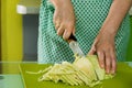 Women's hands cut the cabbage on green chalkboard Royalty Free Stock Photo