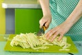 Women's hands cut the cabbage on green chalkboard Royalty Free Stock Photo