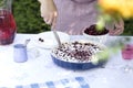 Clafoutis cherry pie.Women`s hands cut a homemade cake Royalty Free Stock Photo