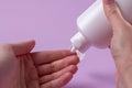 Women's hands with eczema apply the cream to the damaged skin of the hands.