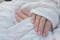 Women's hands with fashionable manicure. Nails with camouflage gel polish on short square nails against the background of a Royalty Free Stock Photo