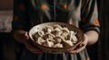 Women\'s hands hold a large plate with dumplings, generative AI tools