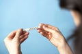 women& x27;s hands hold a medical thermometer, blue background. healthcare concept Royalty Free Stock Photo