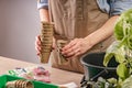 Women`s hands hold peat pots for plants. Process of preparation prepended seedlings for the new season. Unrecognizable person. Royalty Free Stock Photo