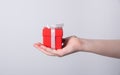 Women`s hands hold a red holiday gift box with a white ribbon Royalty Free Stock Photo