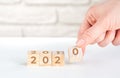 Women`s hands hold wooden cubes 2020. new goals for next year Royalty Free Stock Photo