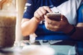 Women`s hands holding cell telephone for your advertising text message or promotional content,in vintage cafe Royalty Free Stock Photo