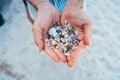 Women`s hands are holding a lot of small pebbles Royalty Free Stock Photo