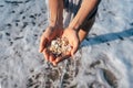 Women`s hands are holding a lot of small pebbles Royalty Free Stock Photo