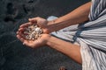 Women`s hands are holding a lot of small pebbles Royalty Free Stock Photo