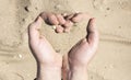 Women`s hands holding sand in his hands in the shape of a heart,the concept of life running out like sand through fingers Royalty Free Stock Photo