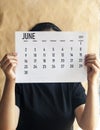 A woman holding simple june 2019 calendar