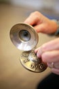 Women`s hands holding Tibetan Tingsha Cymbals for Relaxation, Meditation, and Yoga