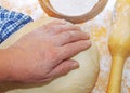 Women's hands knead the dough