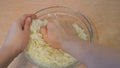 Women`s hands kneaded cabbage. Home kitchen.