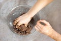 Women`s hands make a gingerbread dough for Christmas pastries. A glass bowl with ingredients stands on the kitchen counter. Royalty Free Stock Photo