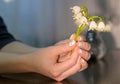 Girl holds a small bouquet of snowdrops