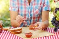 Women`s hands spread jam on piece of bread Royalty Free Stock Photo