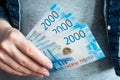 Women`s hands take money rubles out of their wallets