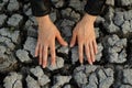 Women's hands touch the dried cracked earth Royalty Free Stock Photo