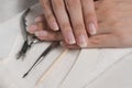 Women`s hands on a towel. Manicure. Manicure tools, nail Polish. Home nail care, SPA, beauty. Long natural nails. Beauty salon Royalty Free Stock Photo