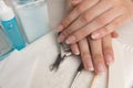 Women`s hands on a towel. Manicure. Manicure tools, nail Polish. Home nail care, SPA, beauty. Long natural nails. Royalty Free Stock Photo