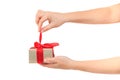 Women`s hands untie the ribbon and open the gift