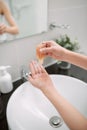 Women`s hands using wash hand sanitizer gel pump dispenser Royalty Free Stock Photo