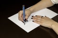 Women`s hands writing on white paper Royalty Free Stock Photo