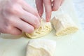 Women`s hands from yeast dough cook buns of different shapes