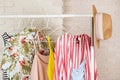 Women`s hip clothing store interior concept. Row of different colorful female clothes hanging on rack in hipster fashion show roo Royalty Free Stock Photo